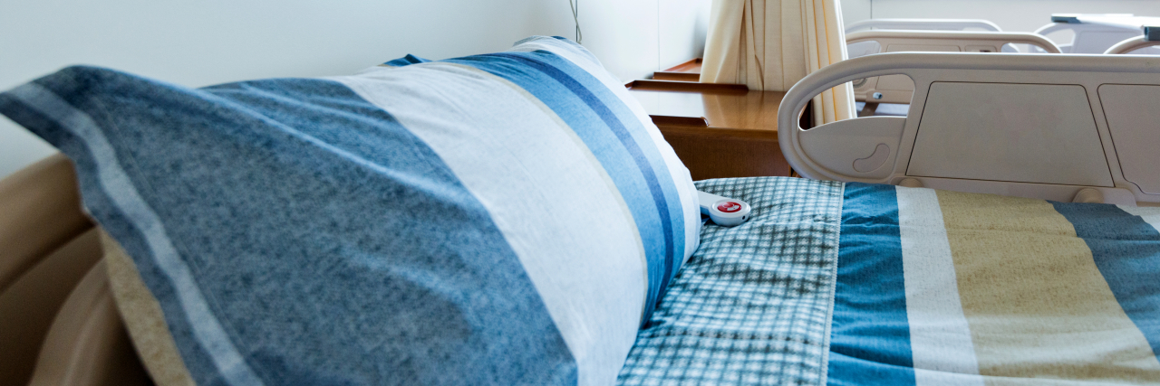 How a Blanket and Pillow Made My Hospital Stay Bearable Close up of hospital gurney with pillow.