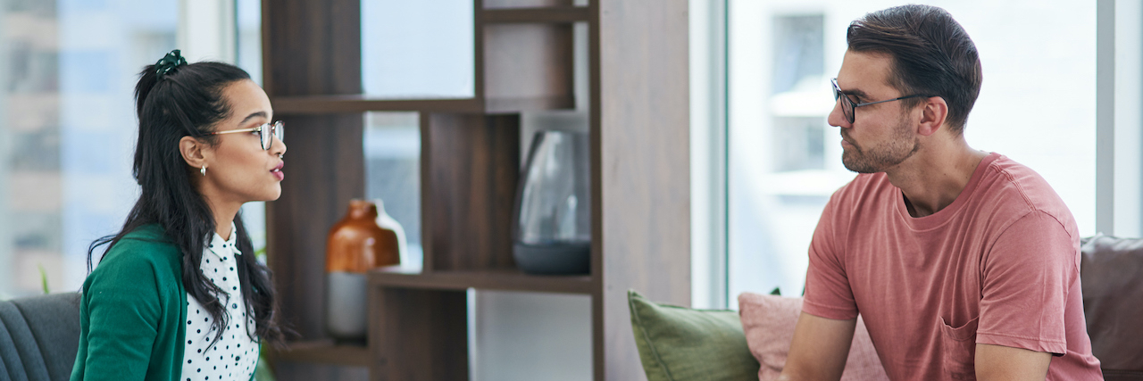 I Had a Public Bipolar Meltdown at Work and HR Came to the Rescue Shot of a young man and woman having a discussion in a modern office