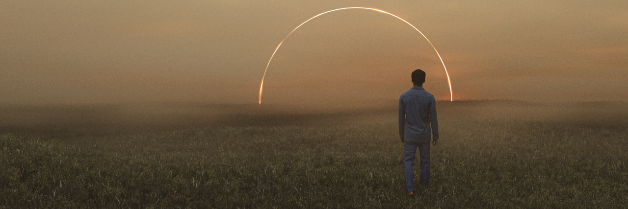 REM Rebound: When Antidepressant Withdrawal Causes Vivid Dreams Dreamy surreal photo of a man walking in a field at sunset with an arc of light in the distance ahead.