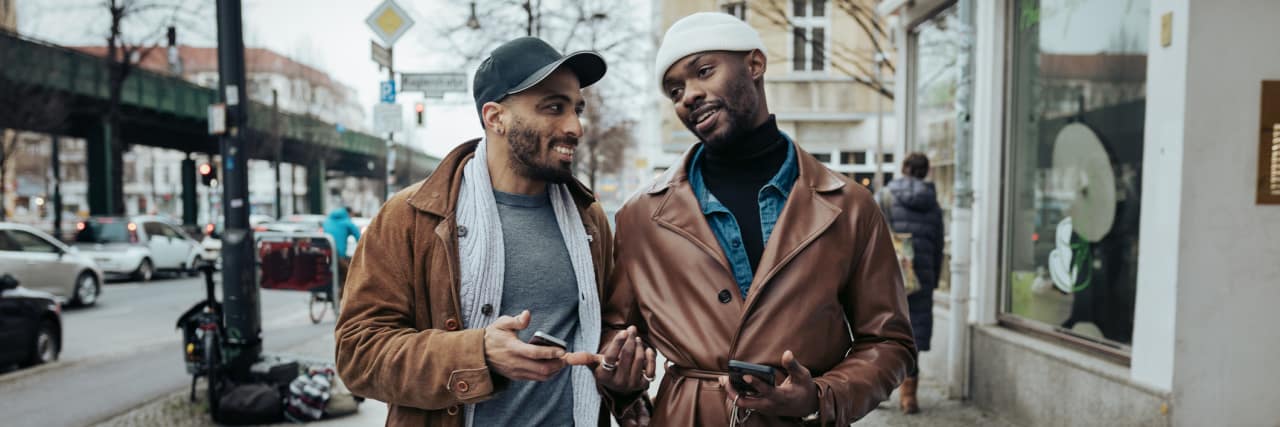 How to Talk to Literally Anyone About Inflammatory Bowel Disease A gay couple walking down the street after meeting each other on a dating app, on their way to eat some food.