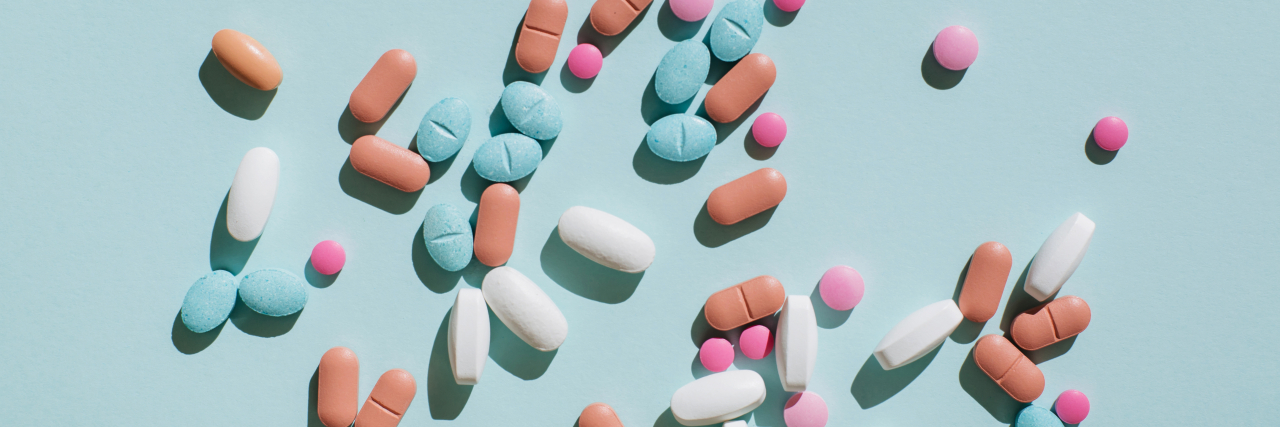 How Roe v. Wade Reversal Affects Access to Autoimmune Treatments Colorful pills and capsules on blue background.