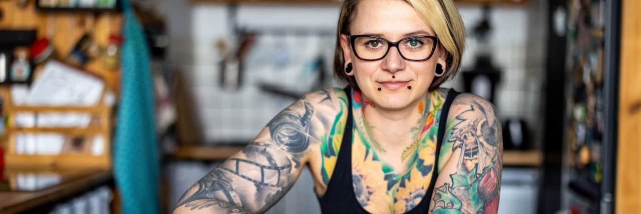 Stop Infantilizing Disabled People Young tattooed woman in a wheelchair.