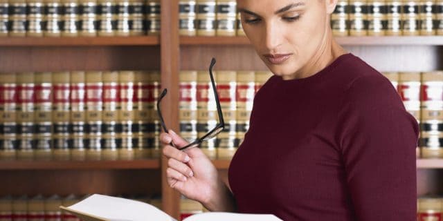 Woman reading law books