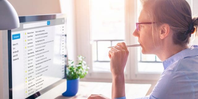 photo of a woman working and replying to emails
