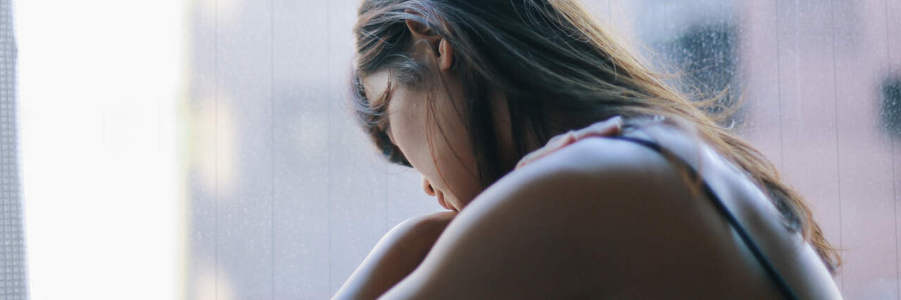 People Share How Borderline Personality Disorder Most Affects Them photo of a woman looking upset in front of a window