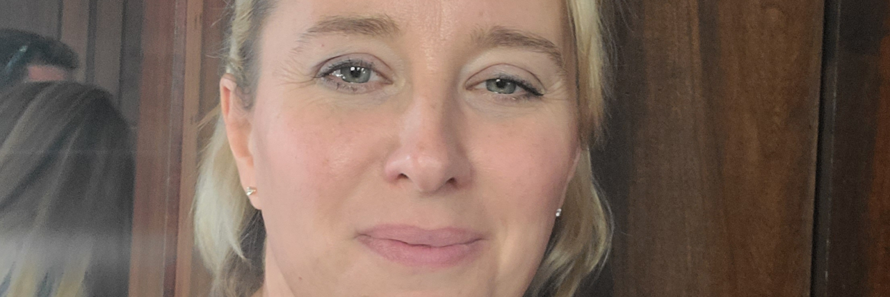 My Ex-Husband Empowers Me to Take Charge of My Health The author, a blonde, blue-eyed woman with her hair up wearing a burgundy shirt.