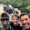 Family hiking near waterfall