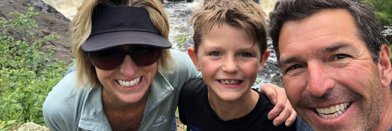 Making Happy Family Memories When Your Child Has Severe Food Allergies Family hiking near waterfall