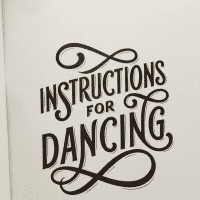 The inside of a book that reads "Instructions for Dancing" in loopy writing against a fur background.