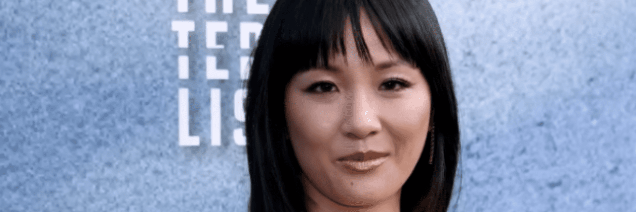 Photo of actor Constance Wu on the red carpet, an Asian American woman with dark hair and bangs