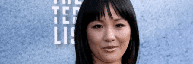 Photo of actor Constance Wu on the red carpet, an Asian American woman with dark hair and bangs