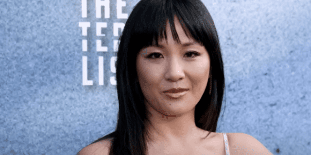 Photo of actor Constance Wu on the red carpet, an Asian American woman with dark hair and bangs