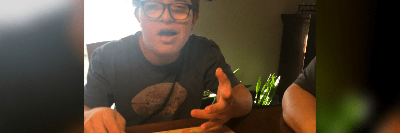 Teaching My Son With Down Syndrome Life Skills George, a teen with Down syndrome, cutting strawberries.