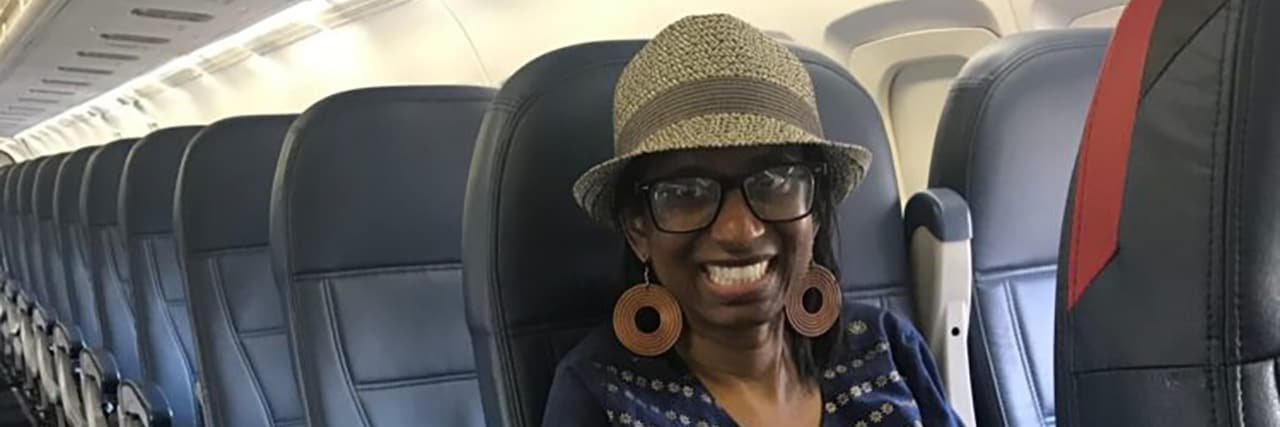 How Imaginary Journeys Help Me Cope With Multiple Sclerosis Nicole sitting on an airplane