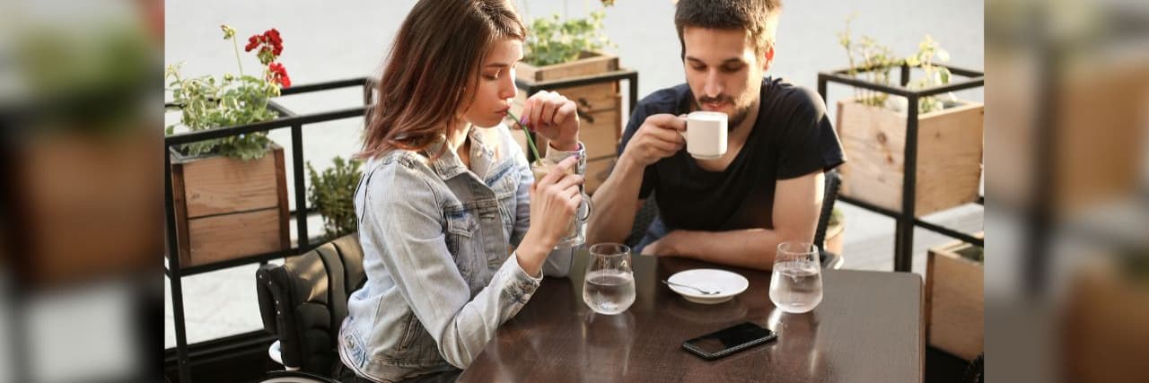 Want to Make Dining Out While Disabled Less Aggravating? Here’s Where to Start. Disabled young woman and her boyfriend in a cafe. Both about 25 years old, Caucasian people.