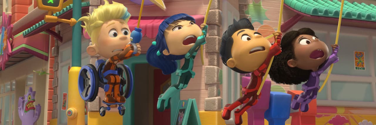 Interview With 13-Year-Old Actor Hartley Bernier From 'Team Zenko Go' on Netflix Team Zenko Go characters, including Ari, who is sitting in his wheelchair and swinging on a rope through town