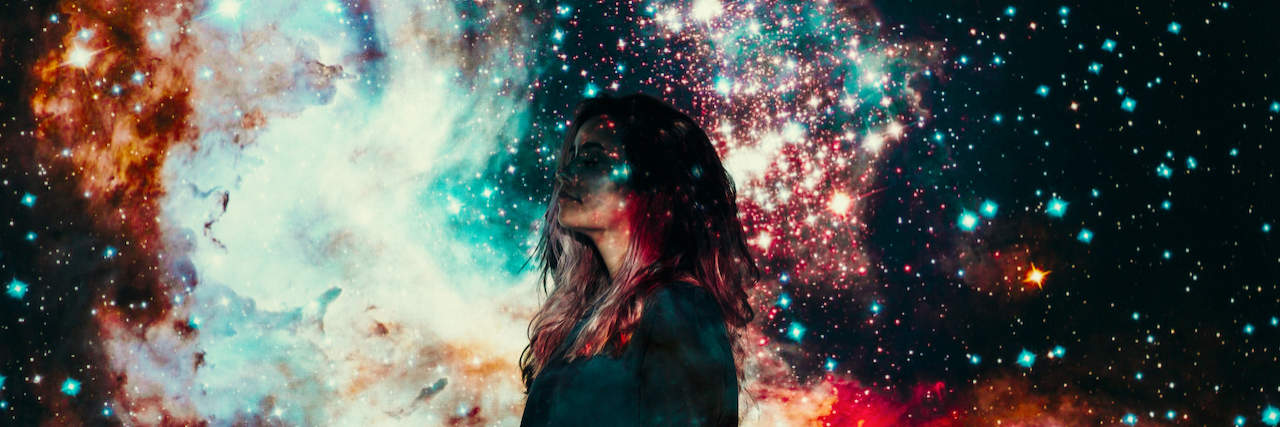 Woman looking to the side with images from space and universe projected onto her