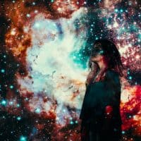 Woman looking to the side with images from space and universe projected onto her