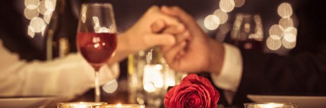 Couple with rose at a romantic dinner