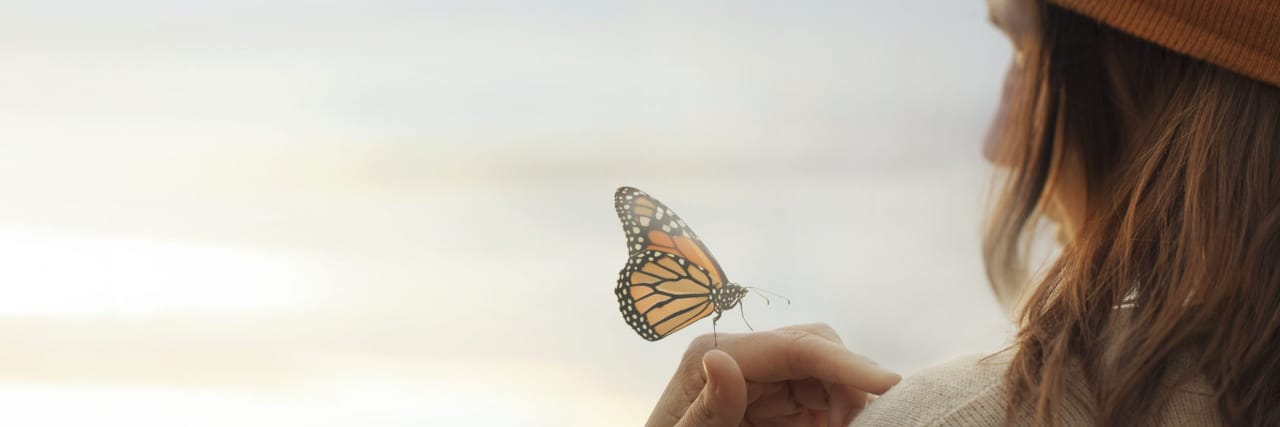 How to Get Through a Bad Week With Chronic Illness Monarch butterfly on a woman's hand.