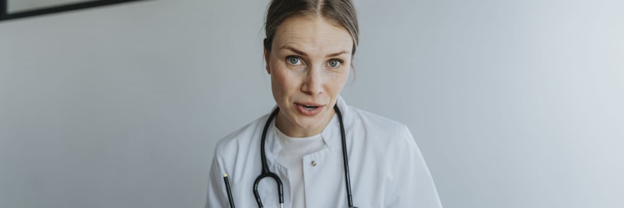 What Makes a Good Gastroenterologist vs. a Bad Gastroenterologist Female doctor discussing treatment while sitting at desk