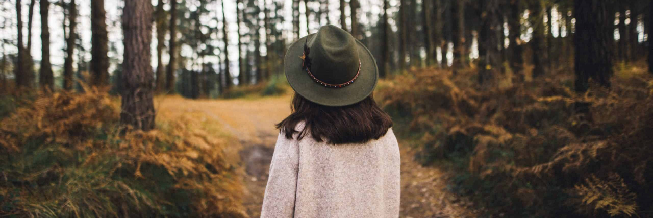5 Tips for Being Active Again When Your Health Has Kept You Sidelined Woman with hat walking in the woods.