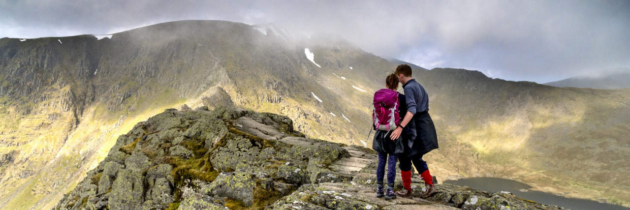 Grieving My Partner's Potential New Diagnosis — One Step at a Time Couple arm in arm walking up a hill