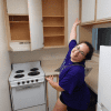 Contributor standing in front of empty shelves in kitchen of old apartment