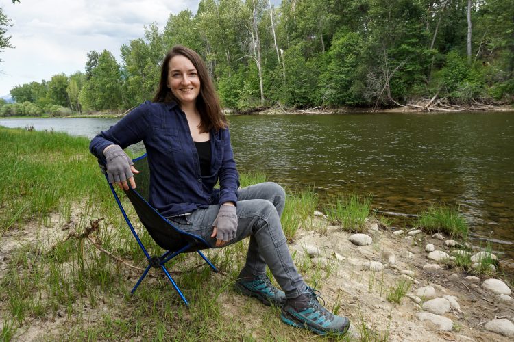 Contributor sitting on a portable chair in front of a beautiful river and trees