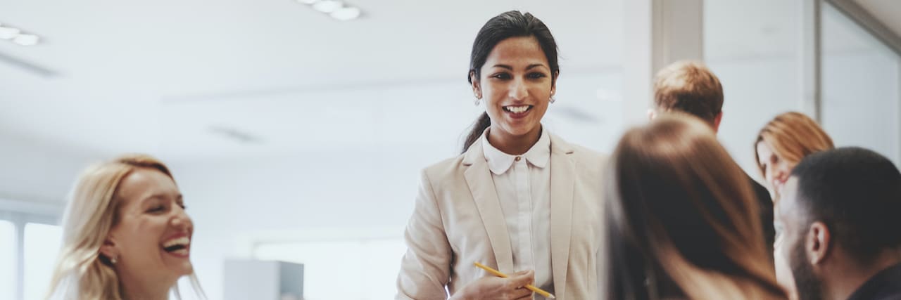 Colleagues Who Have Knowingly or Unknowingly Helped My Mental Health Business woman of color smiling and speaking with colleagues