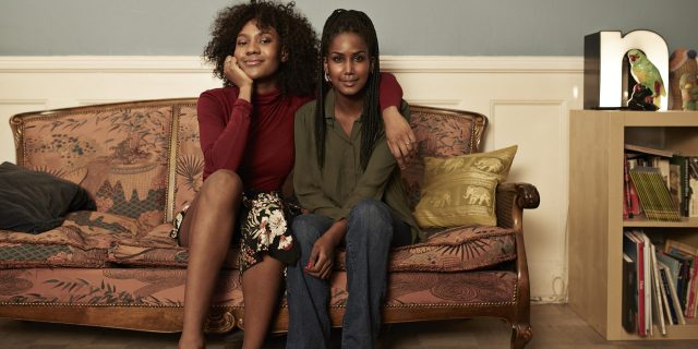 Two young women in sofa at home