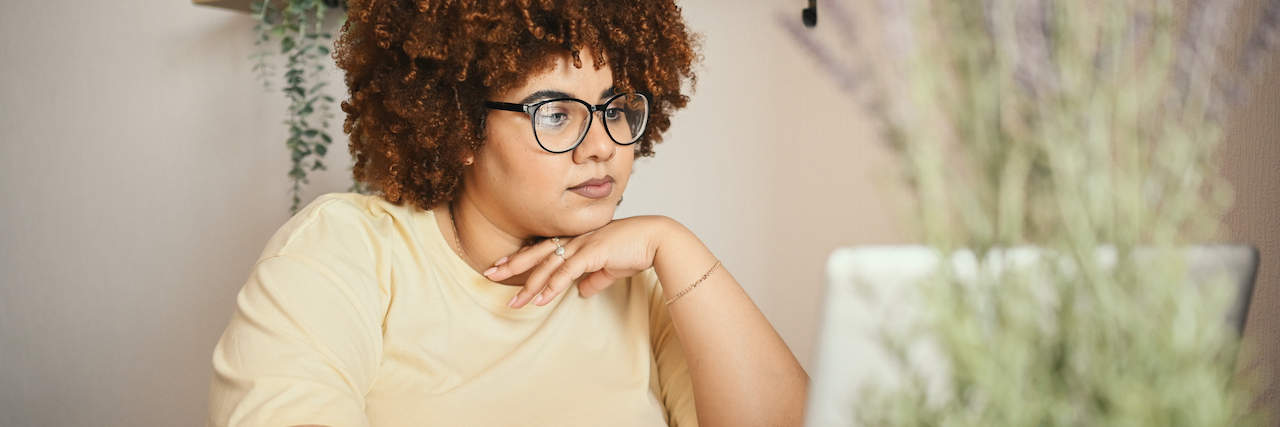The White House Conference on Hunger, Nutrition, and Health Perpetuates Weight Stigma Large Black woman looking at computer with coffee mug at home