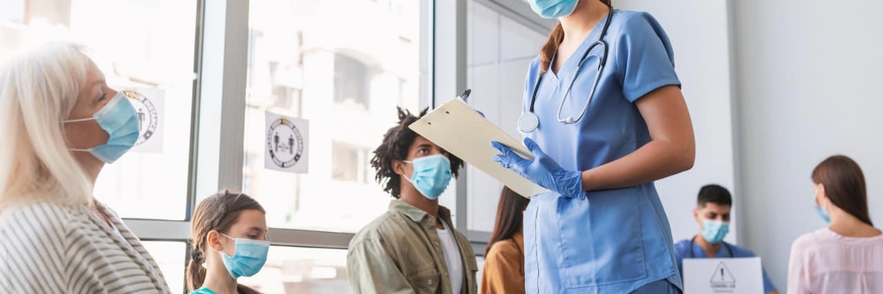 Patients in busy medical waiting room.