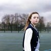 Young girl standing on basketball court