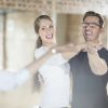 Smiling dance partners together in dance class with instructor