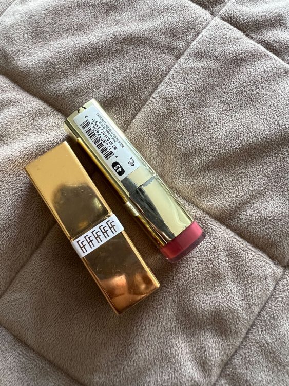 A gold tube of "Fashion Fair" lipstick and a gold tube of "Milani" lipstick