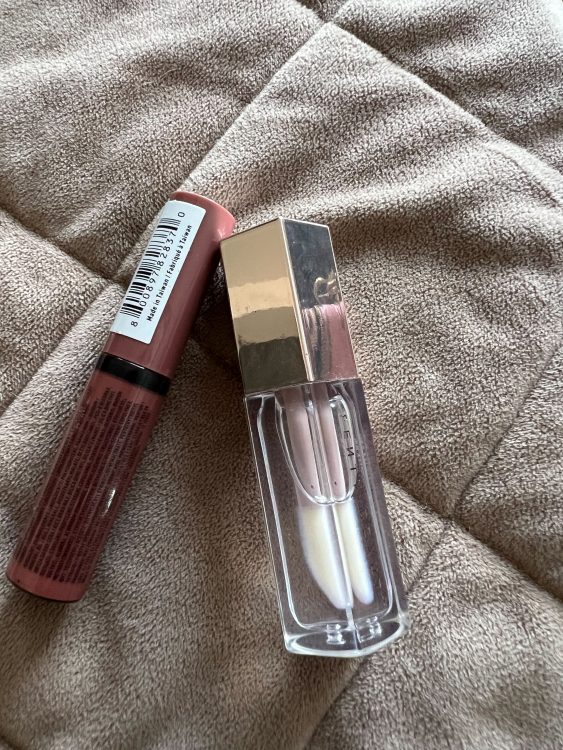 A tube of clear Fenty lip gloss and tube NYX buttergloss