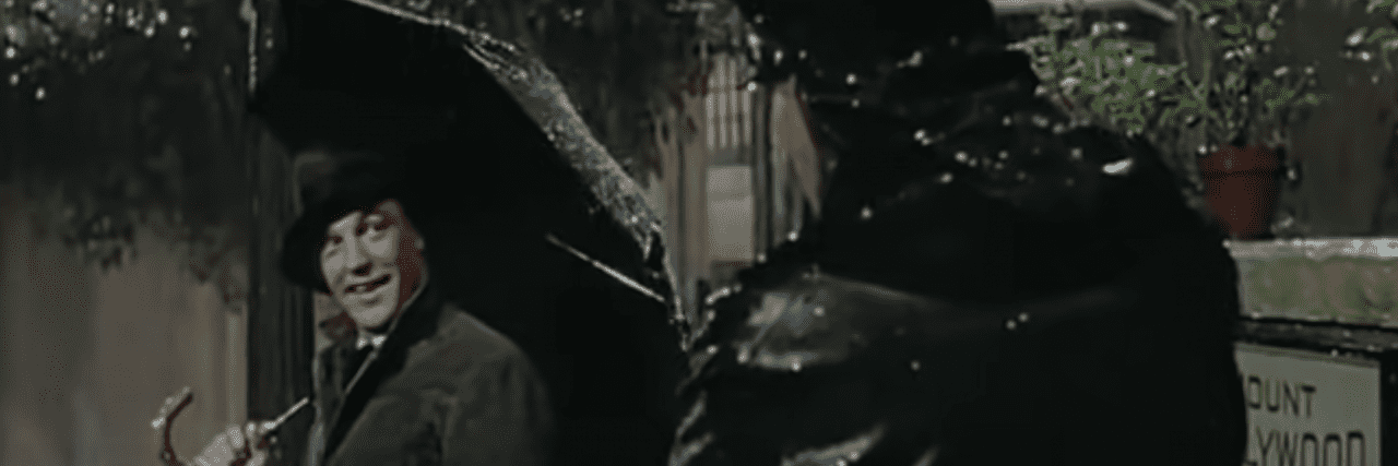 5 Classic Movies to Watch When Your Depression Makes Life Hard Gene Kelly in "Singing in the Rain" staring at a cop in the rain during the "Singing in the Rain" musical sequence in the movie.