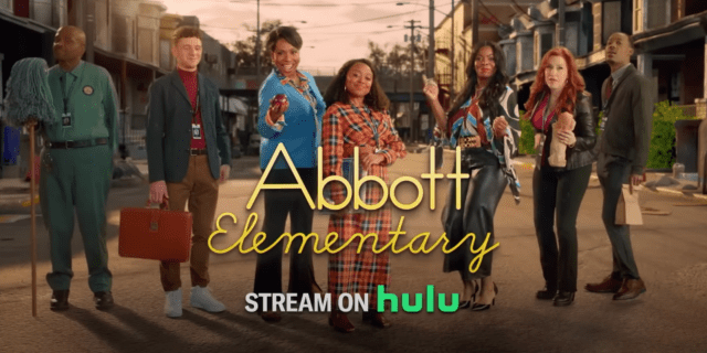 The main cast of "Abbott Elementary" lined up with Philly in the background. In yellow words "Abbott Elementary" is centered and "stream on hulu" is on the bottom of it.