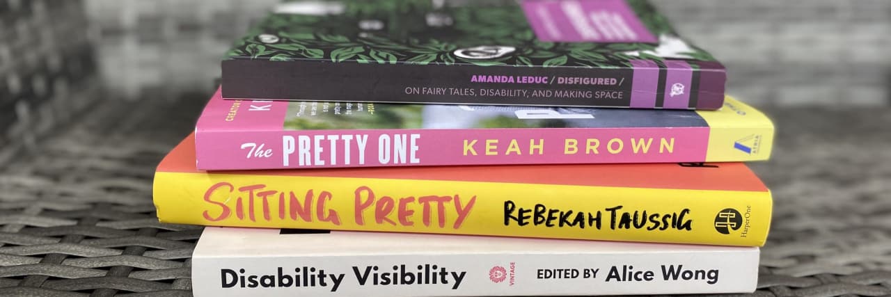 Read These Powerful Contemporary Books by Disabled Authors Spines of books: "Disability Visibility," "Sitting Pretty," "The Pretty One," and "Disfigured"