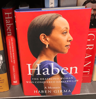 Photo of book cover of Haben Girma's memoir, with a side portrait of the author