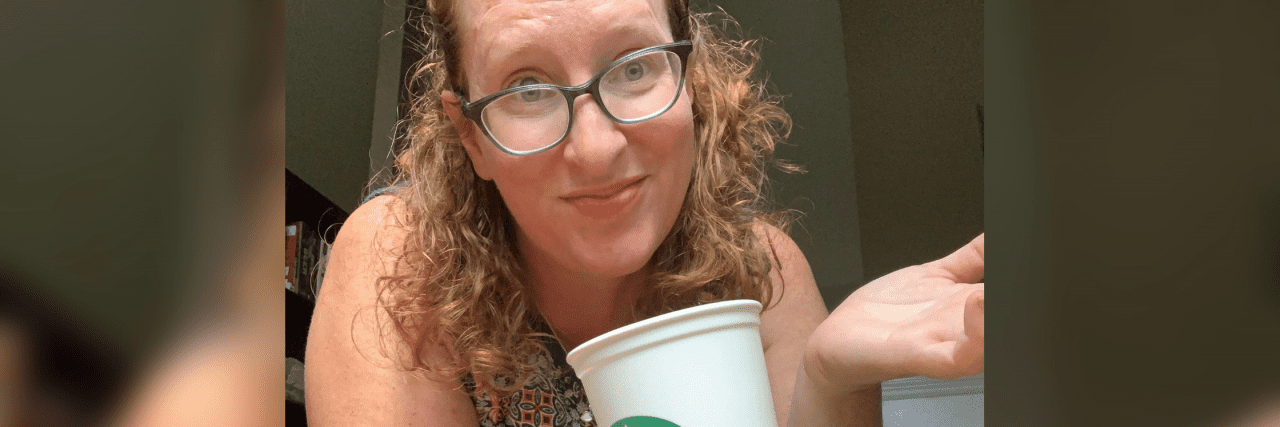 Kristin holding a Starbucks cup