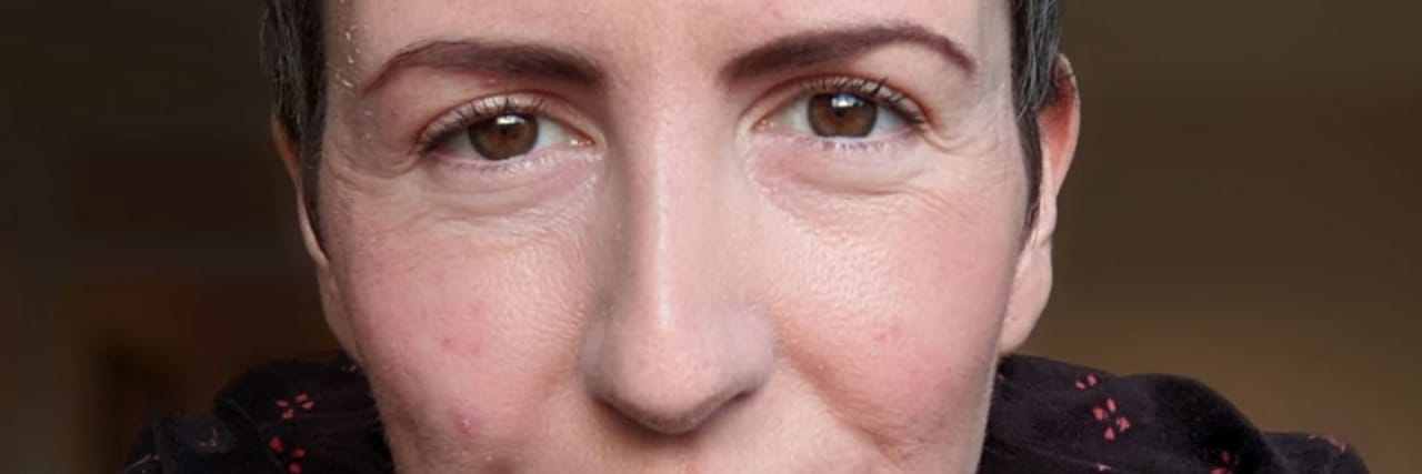 My Work Burnout Led to an Esophageal Cancer Diagnosis — and a Feeding Tube The author, a woman with short dark brown hair wearing a black shirt with a red pattern.