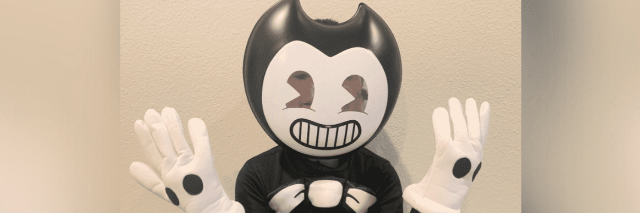 Image of boy wearing black and white "Bendy" costume