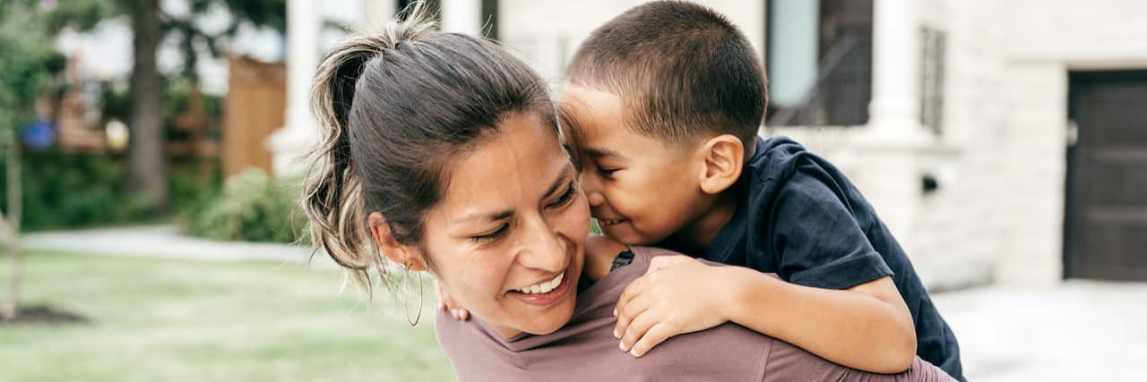 Resources for Parenting Adopted Children With Trauma Mother carrying young child on her back