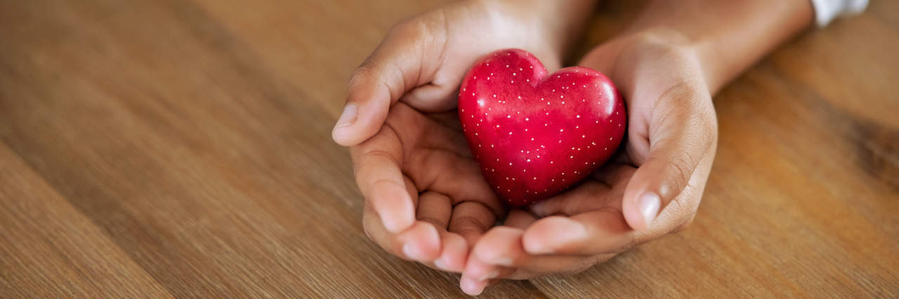 Anosognosia: Helping Those Who Don't Realize They Have Mental Illness Hands holding red heart