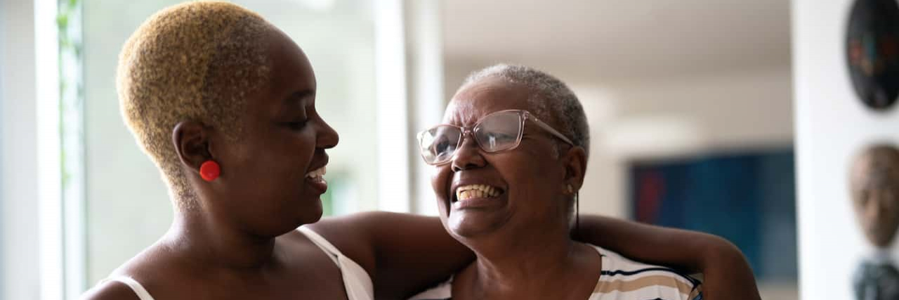 Easy Ways to Support the Caregiver in Your Life Black older mother and daughter embracing at home