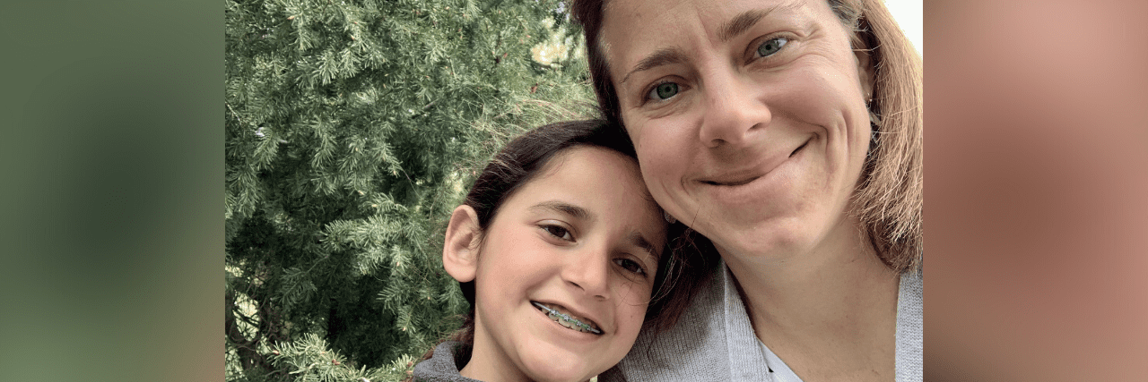 Therapy Helps Me Be a Better Mom Contributor smiling with her daughter in front of greenery