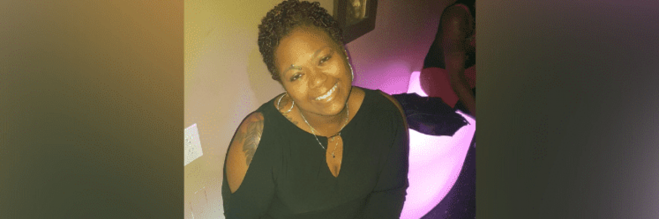 This Is What It's Like to Date When You're Black With Chronic Illness Contributor wearing a black dress and smiling up at the camera