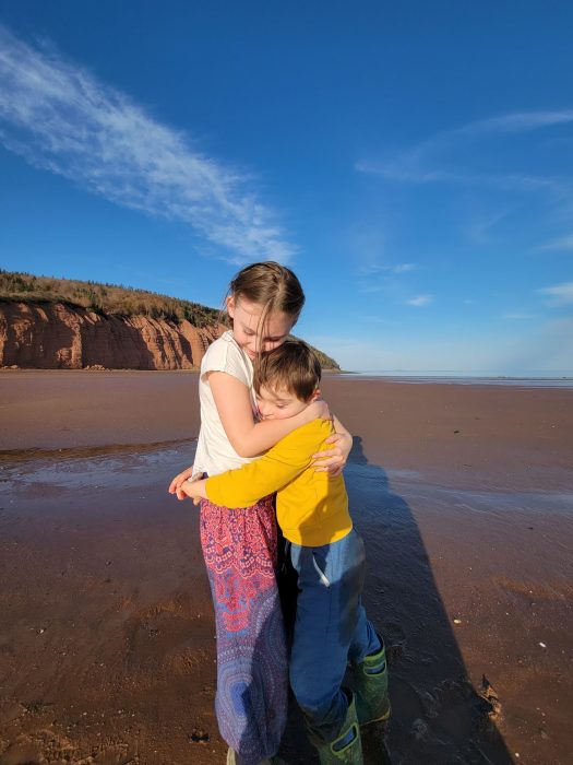 Contributor's children hugging on a beach